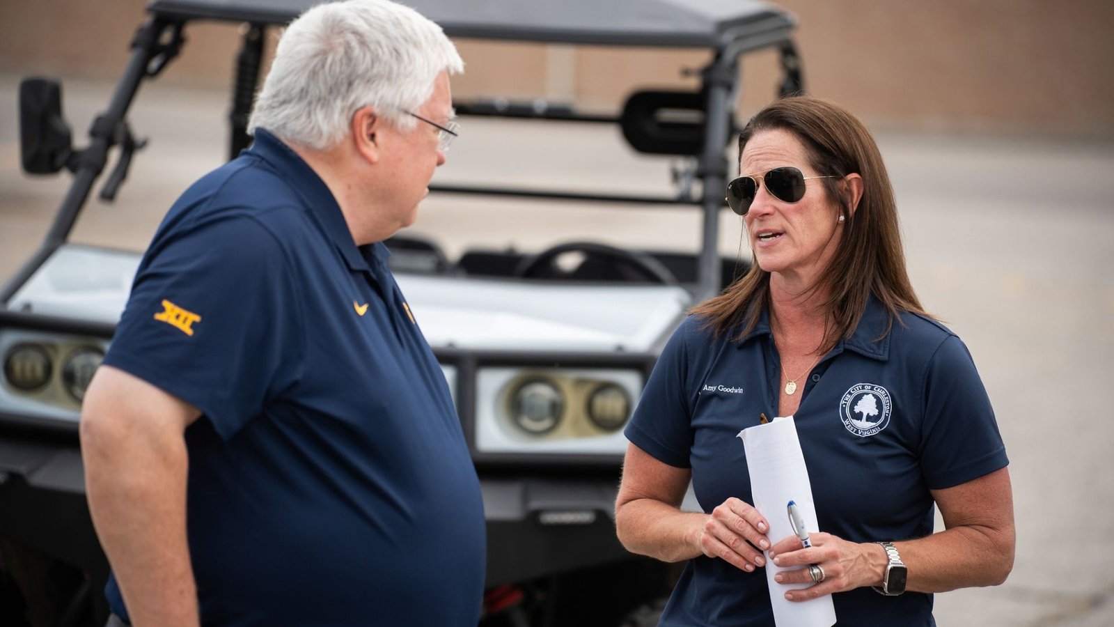 West Virginia Gov. Patrick Morrisey speaks with Charleston Mayor Amy Shuler Goodwin during a tour of flood-damaged areas of Charleston in August 2026