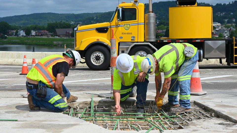 DOT workers repair a portion of an interstate highway.